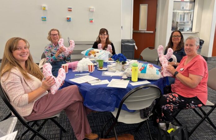 WCV members holding Finshed Pillows
